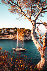 Luxury sail yacht is the best way to travel and spend time at the sea. Sunset view of a bay with...