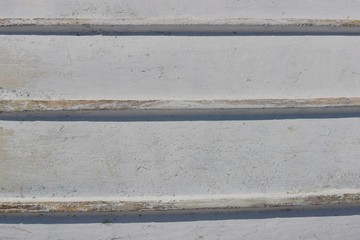 Closeup of the bottom of a white wooden boat