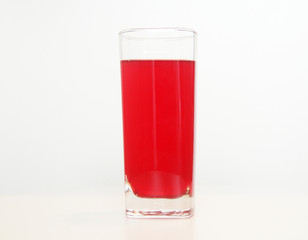 One glass of red  liquid on white background, São Paulo, Brazil