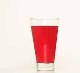 One glass of red  liquid on white background, São Paulo, Brazil