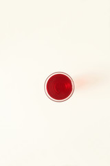 One glass of red  liquid on white background, São Paulo, Brazil