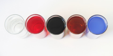 Five Glasses of multicoloured liquid on white background, São Paulo, Brazil
