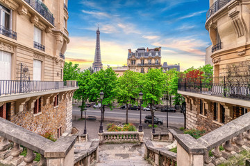 Small Paris street with view on the famous Eiffel Tower in Paris, France.