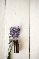 Apothecary lavender oil with a bouquet of flowers. botany. spa. medicine.