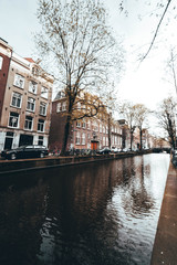 Fototapeta premium Amsterdam canal with buildings on the back