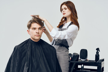 Woman hairdresser doing hairstyle