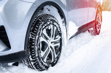 Car fitted with winter tyres on a snowy road