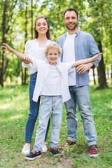Fototapeta premium happy family looking at camera and posing in park