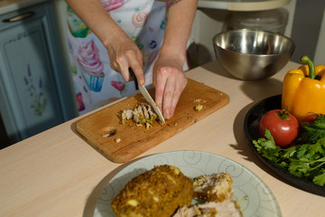 Girl cook cuts meat for a delicious tortilla