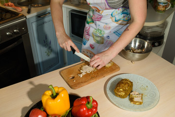Girl cook cuts meat for a delicious tortilla