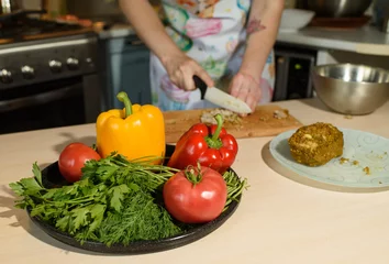 Foto op Canvas Girl cook cuts meat for a delicious tortilla © Павел Костенко