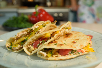 Tasty and juicy tortilla on a glass plate close up