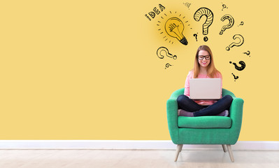 Idea light bulbs with question marks with young woman using her laptop in a chair