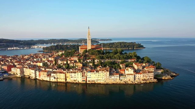 4K. Flight over beautiful Rovinj at sunrise. Morning aerial panorama of the old town of Rovinj in fantastic light, Istria, Croatia.