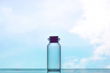 view of silhouette cork and glass bottle with blue sky as background