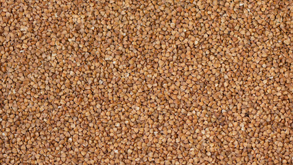 Background of buckwheat. Roasted buckwheat. Ingredient, product, cook. Brown. Agribusiness, crop, organic farming. Dietary product.