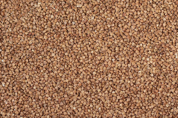 Background, texture, the rump. Buckwheat. Roasted buckwheat. Garnish. Ingredient, product, cook. Brown. Agribusiness, crop, organic farming. Dietary product.
