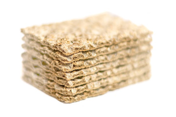 The healthy crispbread isolated on white background. Crispy dietary fitness bread. Food for weight loss. Selective focus in the foreground