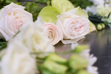 Beautiful white and pink flowers lie on the table for making up a beautiful wedding bouquet. Concept of master class of florist and wedding decor