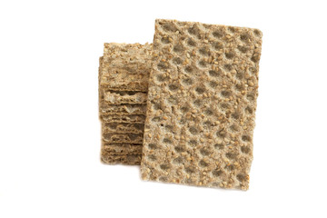 One main crispbread against the background of stack of crispbread with sesame isolated on white