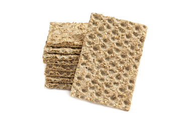 One main crispbread against the background of stack of crispbread with sesame isolated on white