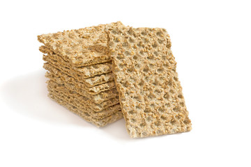 One main crispbread against the background of stack of crispbread with sesame isolated on white