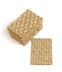One main crispbread and stack of crispbread with sesame isolated on white. Top view. Vertical