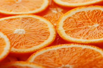 Slices of ripe orange backlit as a textural background. Full screen, close-up, macro