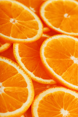 Slices of ripe orange backlit as a textural background. Full screen, close-up, macro
