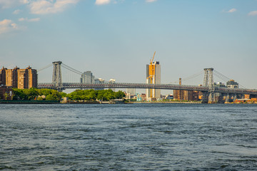 Manhattan Bridge and buildings on East river side view from Brooklyn