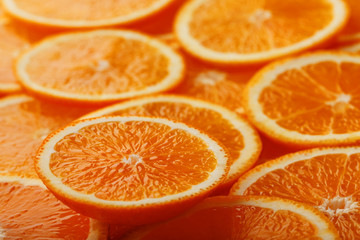 Slices of ripe orange backlit as a textural background. Full screen, close-up, macro