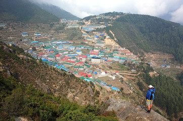 Tourist enjoying view of Namche Bazaar village in Sagarmatha national park, Khumbu valley, Nepal