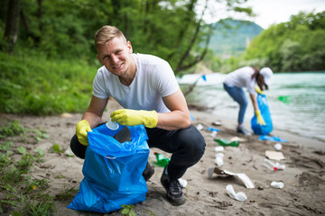 Cleaning river beach from garbage