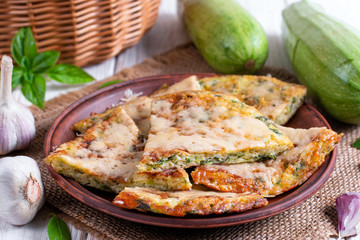 Homemade pie with zucchini, cheese and herbs