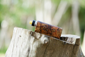 high end natural stabilized wood box mods with rebuildable dripping atomizer, vaping device, selective focus