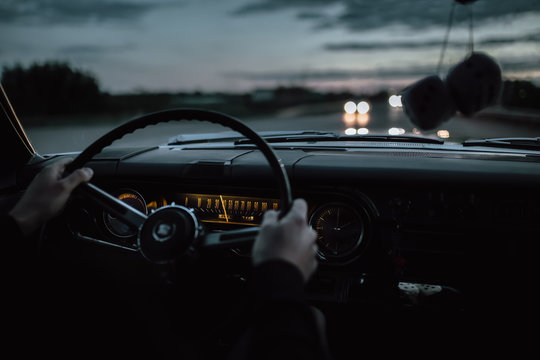 Engels, Russia - June 08, 2018: Black Retro Vintage Muscle Car Cadillac Fleetwood Brougham Is Driving At Countryside Asphalt Road At Dusk. View From Interior