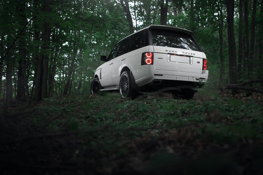 Saratov, Russia - August 08, 2016: White car Land Rover Range Rover is parked in the forest