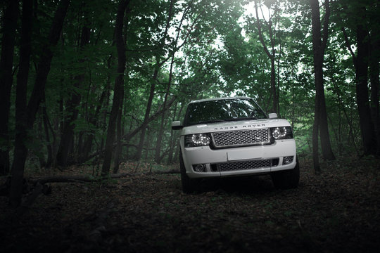 Saratov, Russia - August 08, 2016: White car Land Rover Range Rover is parked in the forest