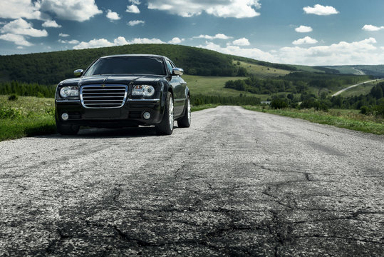 Saratov, Russia - August 9, 2015: Black car Chrysler 300c is standing on asphalt road at daytime