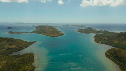 Aerial drone small island group in province of Palawan. Busuanga, Philippines. Seascape, islands covered with forest, sea with blue water. tropical landscape, travel concept