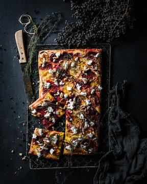 Pizza with cottage cheese and beetroot topped with timian herb