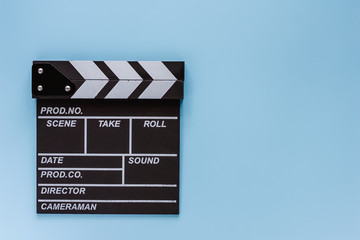 Fototapeta na wymiar Movie clapper board on blue background for filming equipment