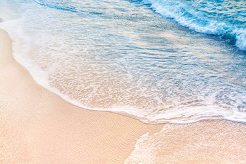 Beautiful sea summer background. Soft wave of blue clear ocean on a sandy beach.