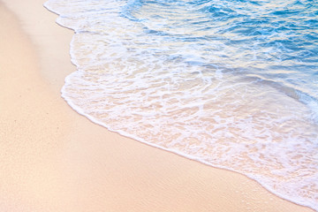 Fototapeta na wymiar Beautiful sea summer background. Soft wave of blue clear ocean on a sandy beach.