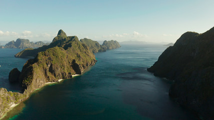 Bay and the tropical islands. Seascape with tropical rocky islands, ocean blue wate, aerial view. islands and mountains covered with tropical forest. El nido, Philippines, Palawan. Tropical Mountain