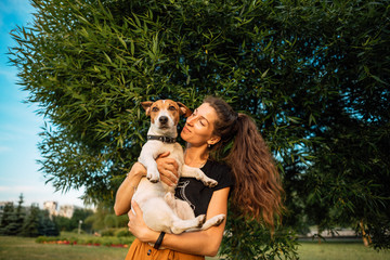 Obraz premium girl with dog play. person and pet together. little Jack Russell Terrier