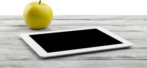 Apple and digital tablet.
