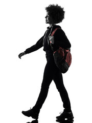one mixed race african young teenager girl woman walking smiling in studio shadow silhouette...