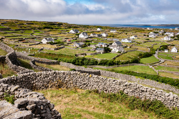 Mortarless stone walls and village on Inisheer Aran islands Ireland