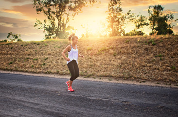 Shapely and athletic girl runs on a sunny day outside